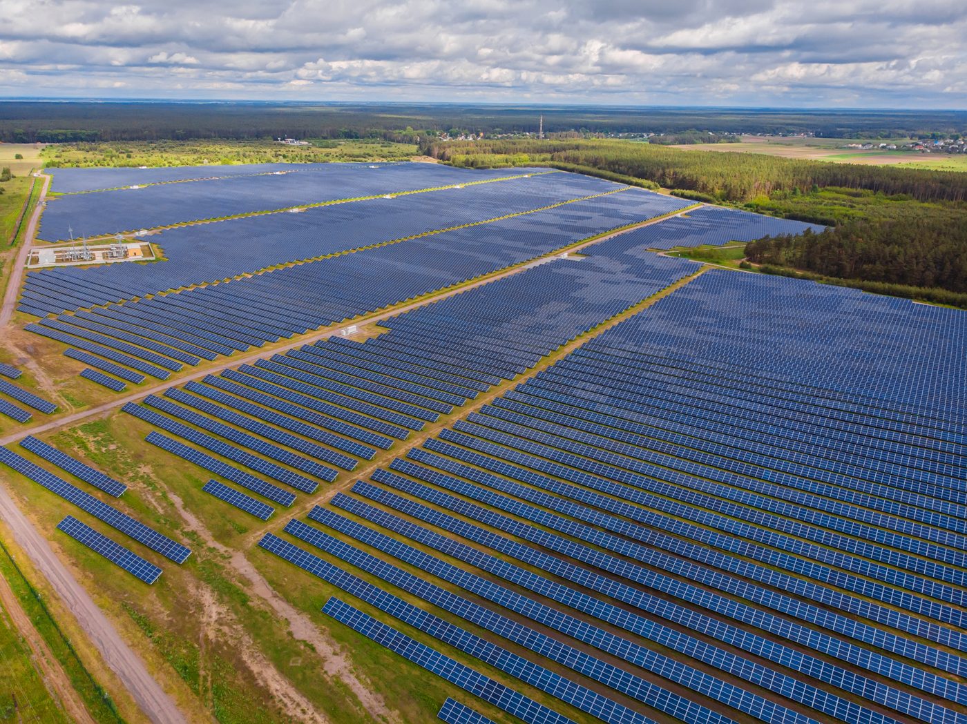Aerial view of commercial solar panels at sunset