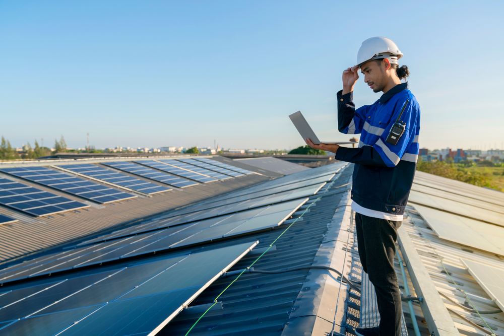 Solar installer on a rooftop during a consultation